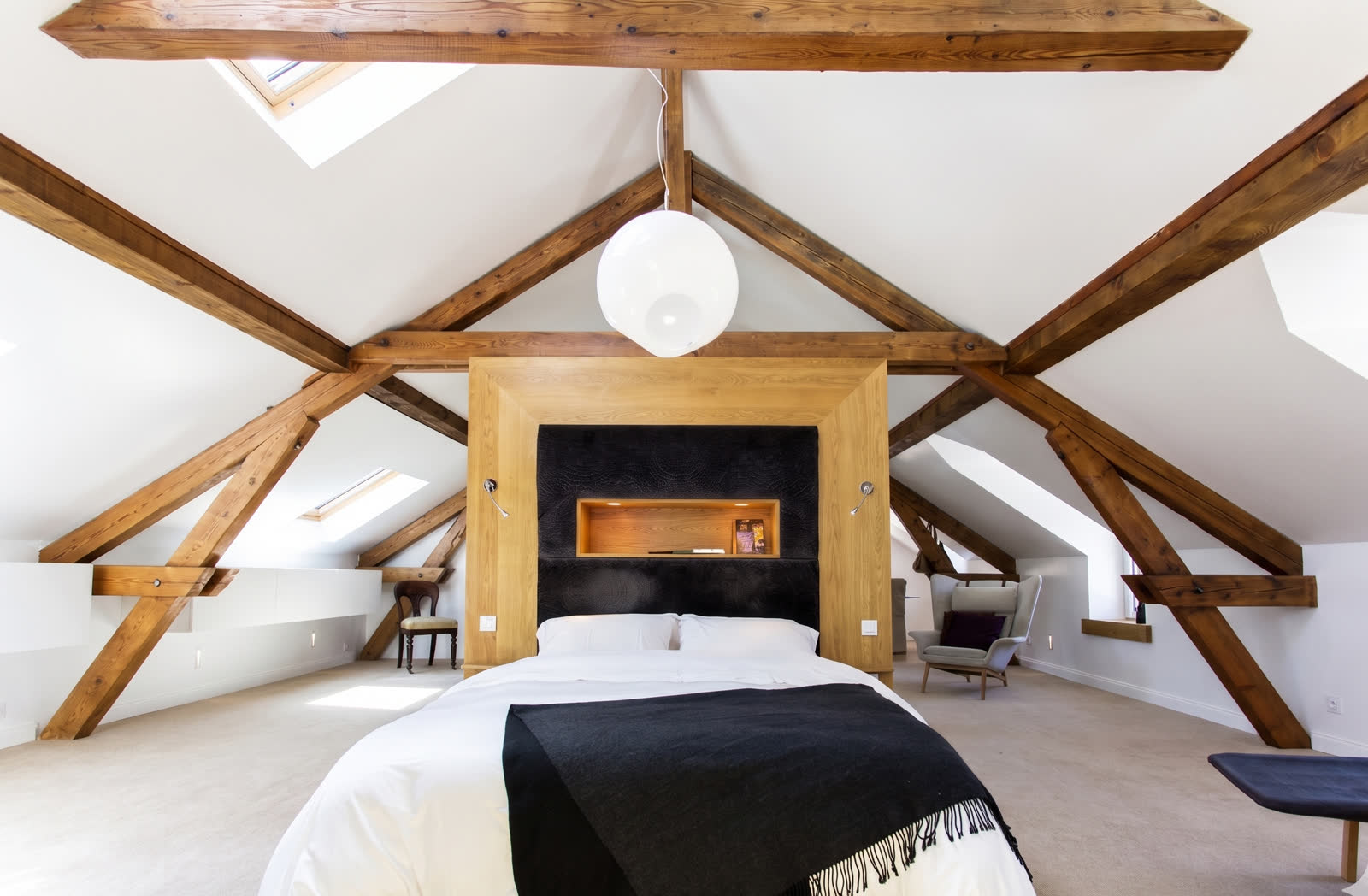 Attic bedroom with exposed timber trusses, Annecy lakehouse