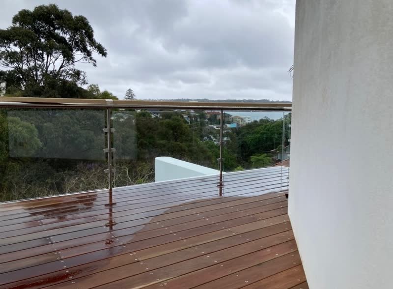 Deck with glass balustrade, water view, completed by Tillow Built