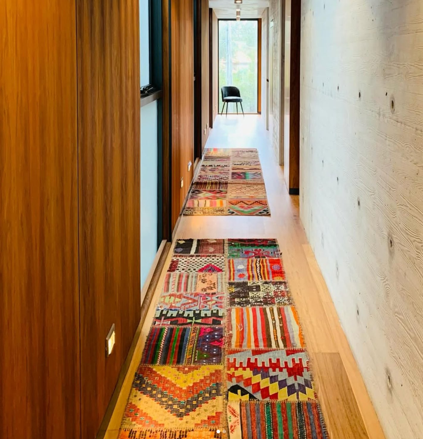 Timber flooring hallway with exposed concrete wall